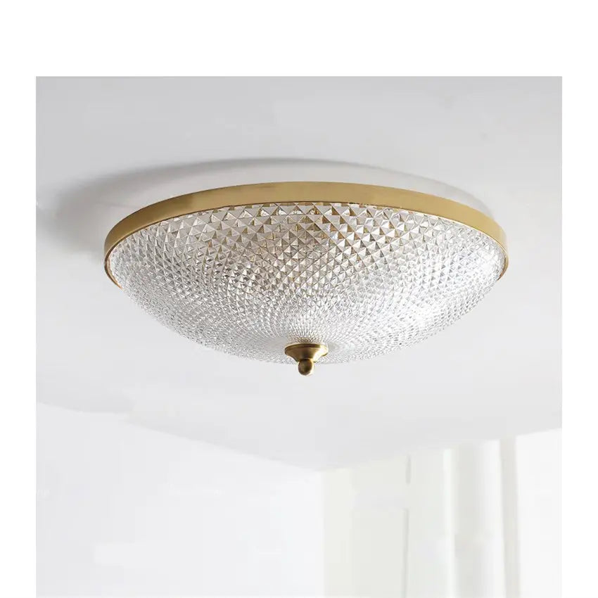 Round ceiling light with clear faceted glass shade and gold trim, flush mount