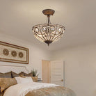 Gold-tone flush-mount ceiling light with crystal-style shade and ornate medallion design