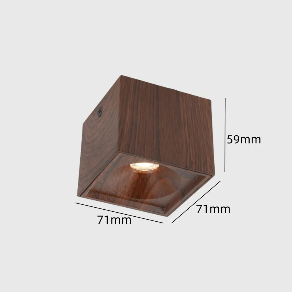 Adjustable wood-grain LED ceiling spotlight showing warm light from diffused lamp head