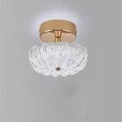 Gold flush-mount ceiling light with clear crystal-style acrylic drum shade