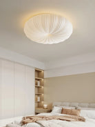 Cream fabric dome ceiling light with ribbed texture in a modern bedroom