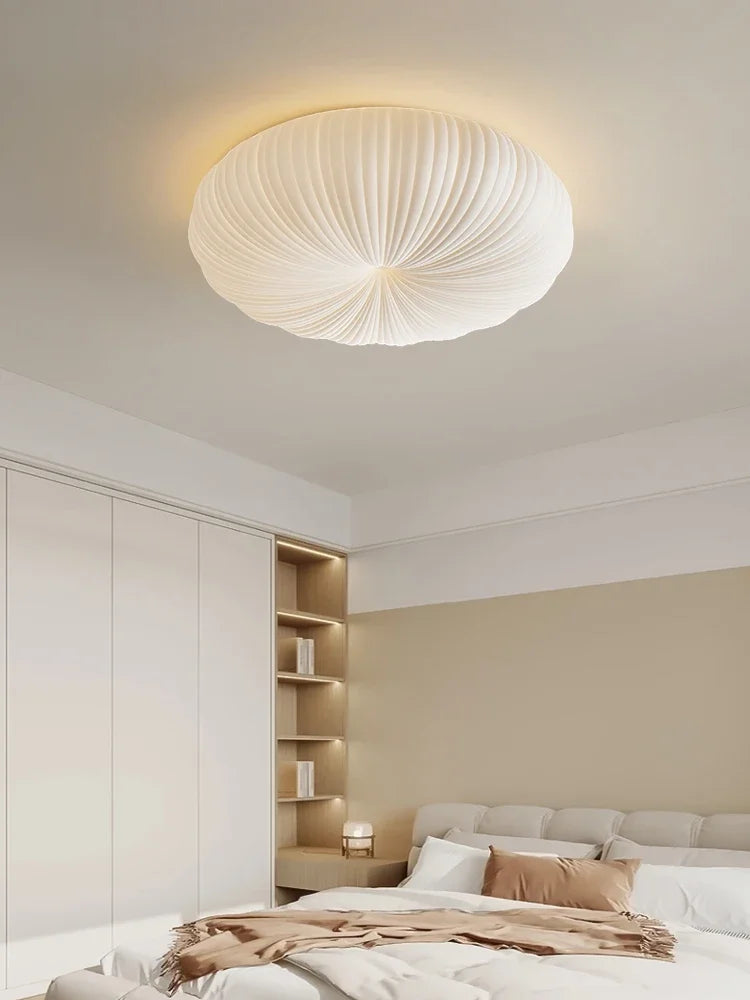 Cream fabric dome ceiling light with ribbed texture in a modern bedroom