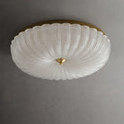 White crystal-style acrylic LED flush-mount ceiling light with scalloped diffuser and brass cap