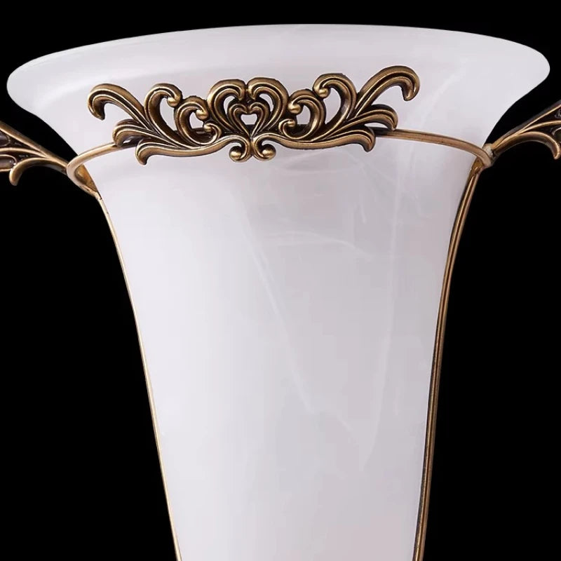 Ornate gold wall sconce with frosted glass shade, front view