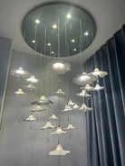 Mushroom-style ceramic chandelier with glowing white shades and hanging crystal drop accents