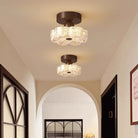 Brown flush-mount LED ceiling light with frosted glass shades on a ceiling