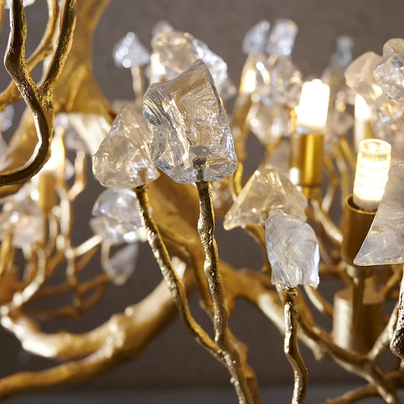 Close-up of crystal chandelier: gold-toned branches with faceted clear crystal pieces