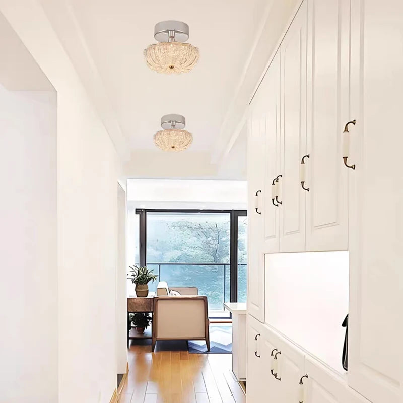 Chrome flush-mount ceiling light with clear crystal-style acrylic drum shade