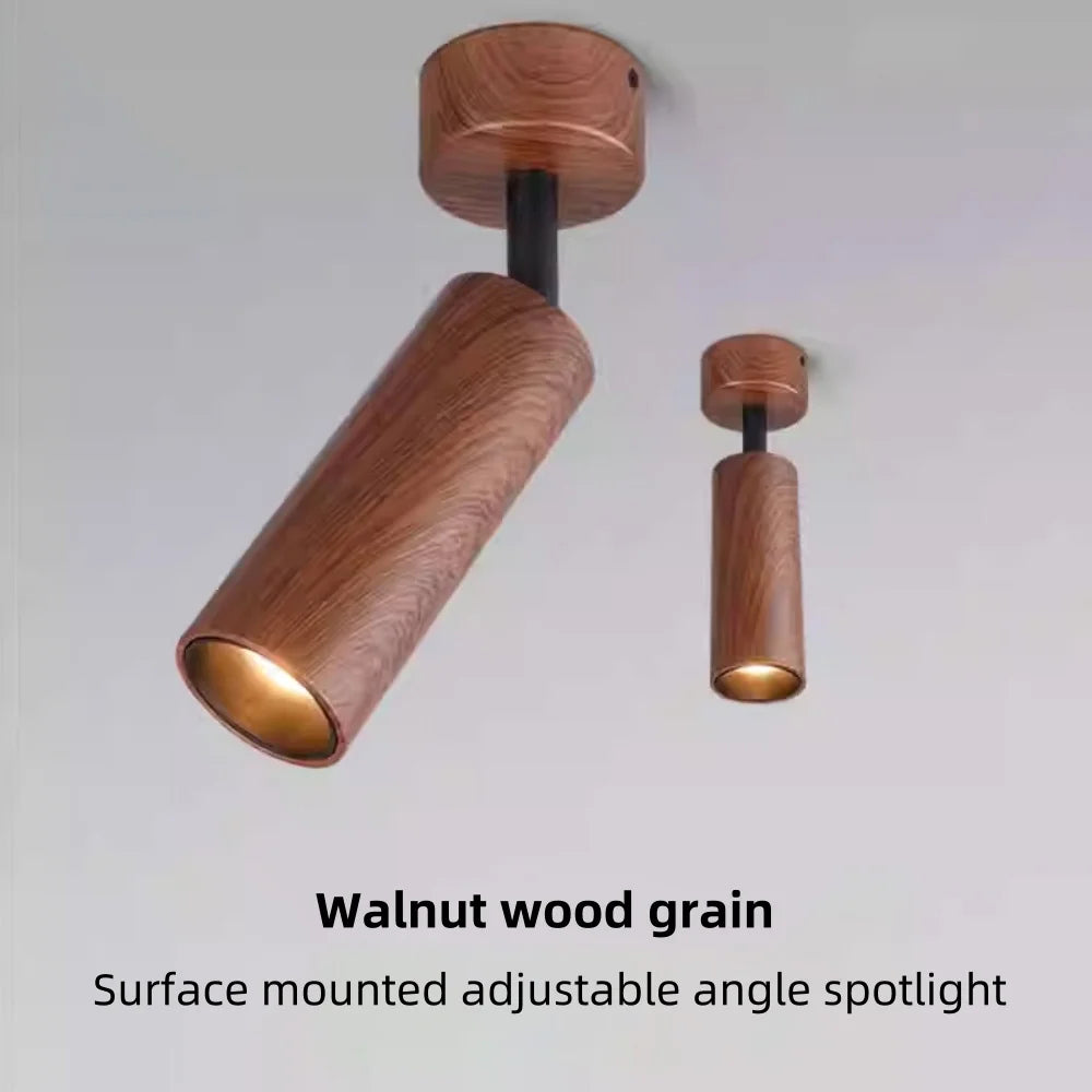 Walnut wood-grain adjustable LED spotlight, angled cylinder design with warm inner light