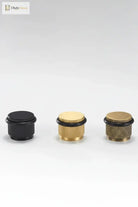 Set of four adjustable knurled floor door stops in black and gold finishes with black rings