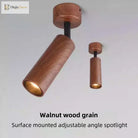 Walnut wood-grain adjustable LED spotlight, angled cylinder design with warm inner light