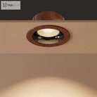 Walnut wood-grain LED ceiling spotlight with circular trim and visible glowing lamp