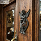 Angel door knocker cast iron featuring winged cupid and a heart knocker plate, dark finish