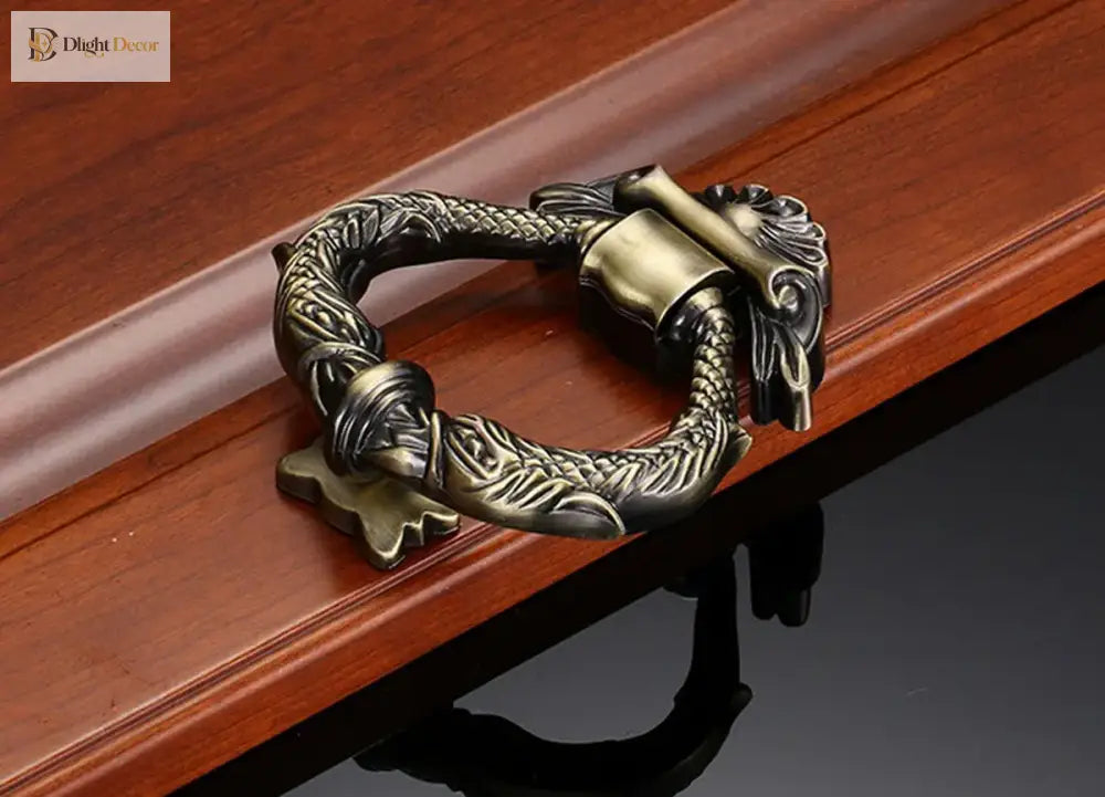 Antique gold zinc alloy door knocker with ornate wreath ring and decorative foot base