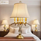 Gold art deco crystal table lamp with pleated cream shade and ornate candle-arm frame