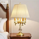 Gold art deco desk lamp with pleated shade and clear crystal centerpiece base