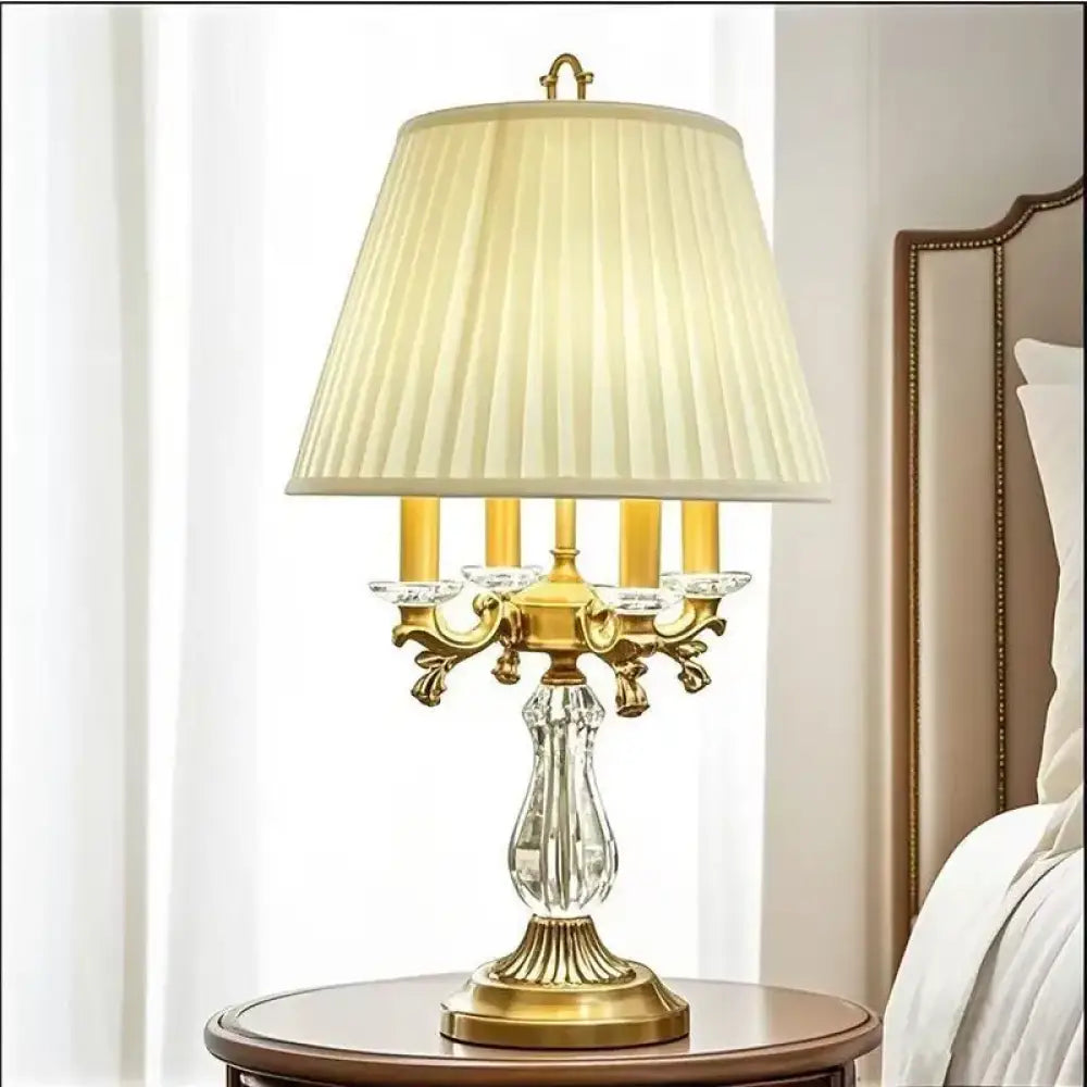 Gold art deco desk lamp with pleated cream shade and clear crystal base