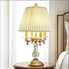 Gold art deco desk lamp with pleated cream shade and clear crystal base