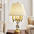 Gold art deco desk lamp with pleated cream shade and crystal column base