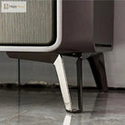 Silvery metal furniture leg with angular base and bracket, mounted under a cabinet
