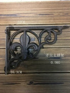 Cast iron shelf bracket with fleur-de-lis scrollwork, dark finish