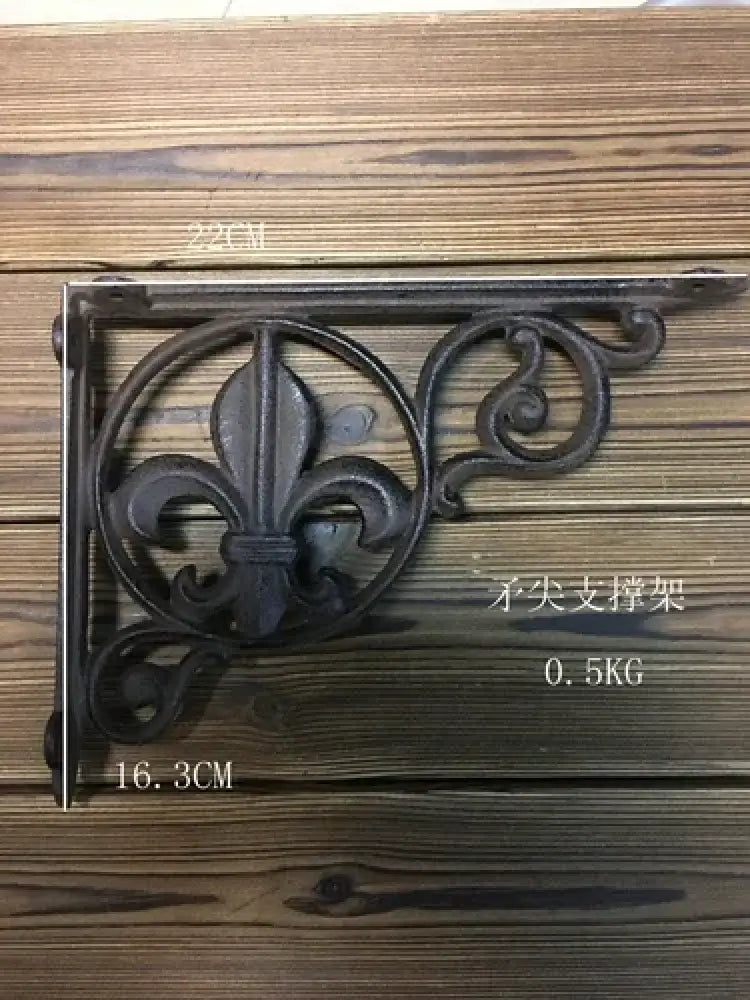 Cast iron shelf bracket with fleur-de-lis scrollwork, dark finish