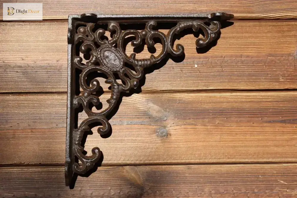 Black cast iron triangle shelf bracket with swirling floral filigree detail