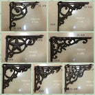 Black cast iron triangle shelf bracket with heart-and-floral scroll cutouts