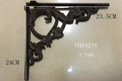 Cast iron right-angle shelf bracket with floral scroll corner, dark finish