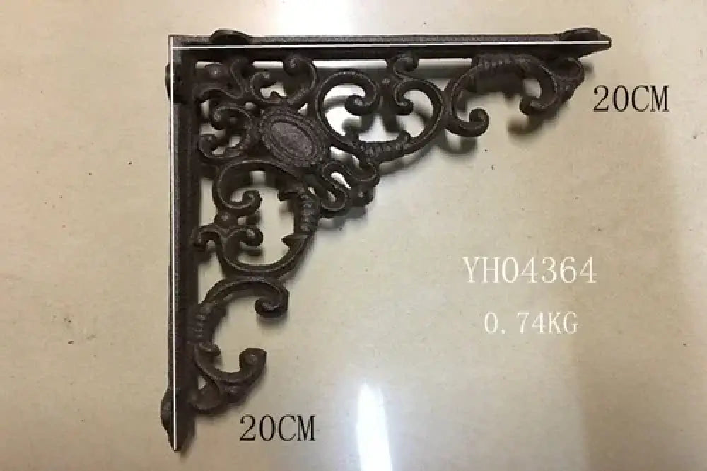 Black cast iron triangle shelf bracket with swirling leaf and scroll pattern