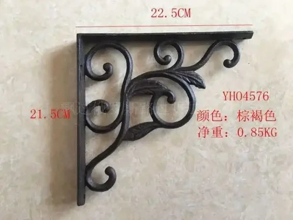 Black cast iron triangle shelf bracket with looping vine and central rosette