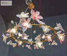 Hanging ceramic flower chandelier with soft pink and white petal lights on gold branches