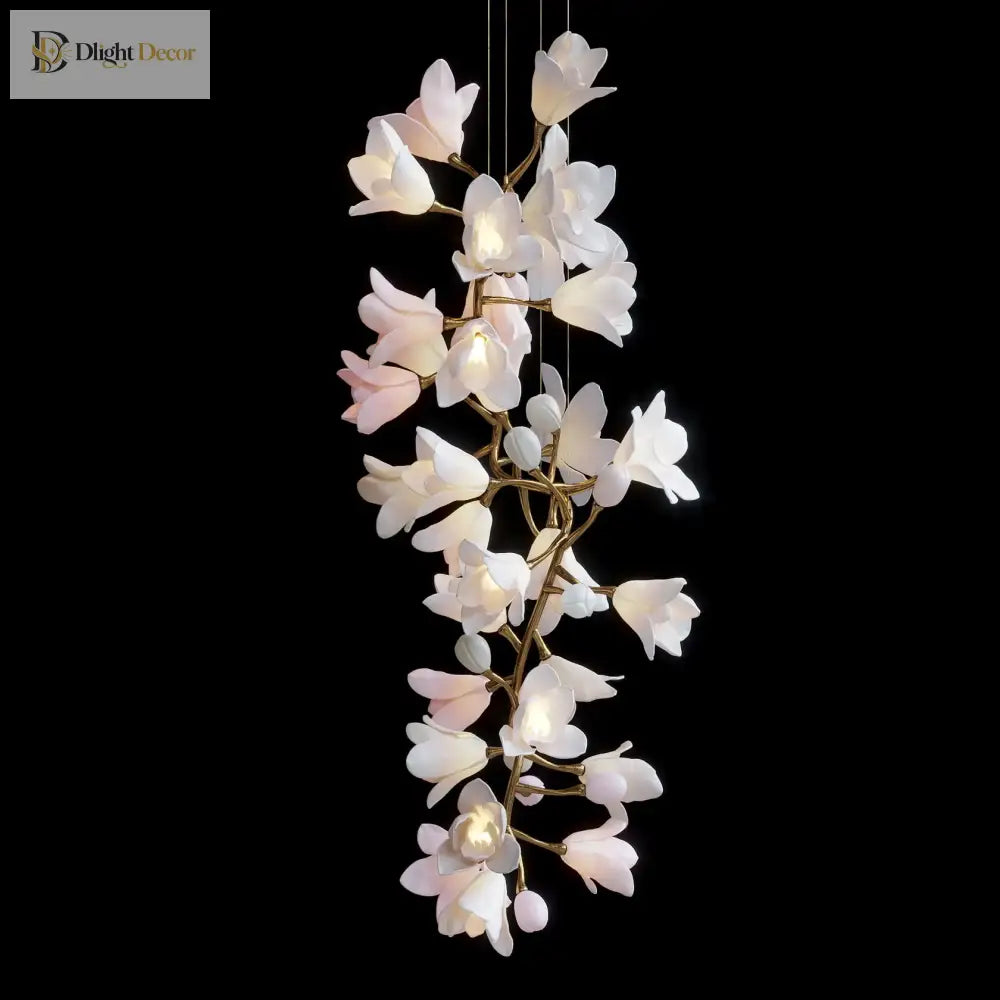 Small ceramic flower chandelier with glowing white petals and gold metal leaf branches