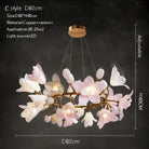 Ceramic flower chandelier with glowing white and pink petals and gold metal arm ring
