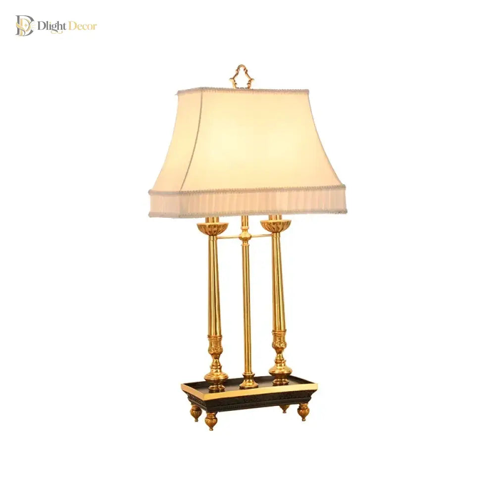 Brass LED desk lamp with beige shade and three posts, front view