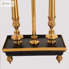 Brass lamp base with three turned posts and black square platform