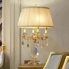 Gold LED table lamp with pleated fabric shade and clear crystal dangling ornaments