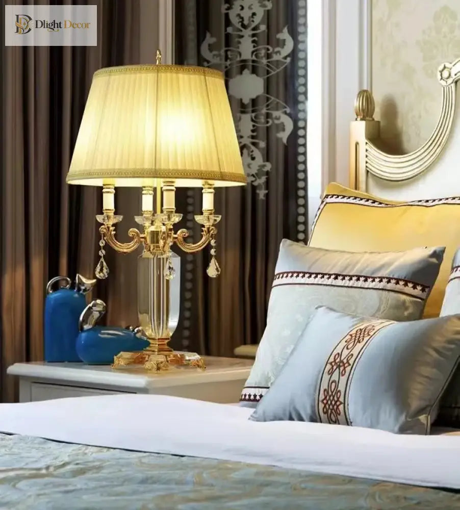 Gold LED table lamp with pleated fabric shade and clear crystal hanging ornaments