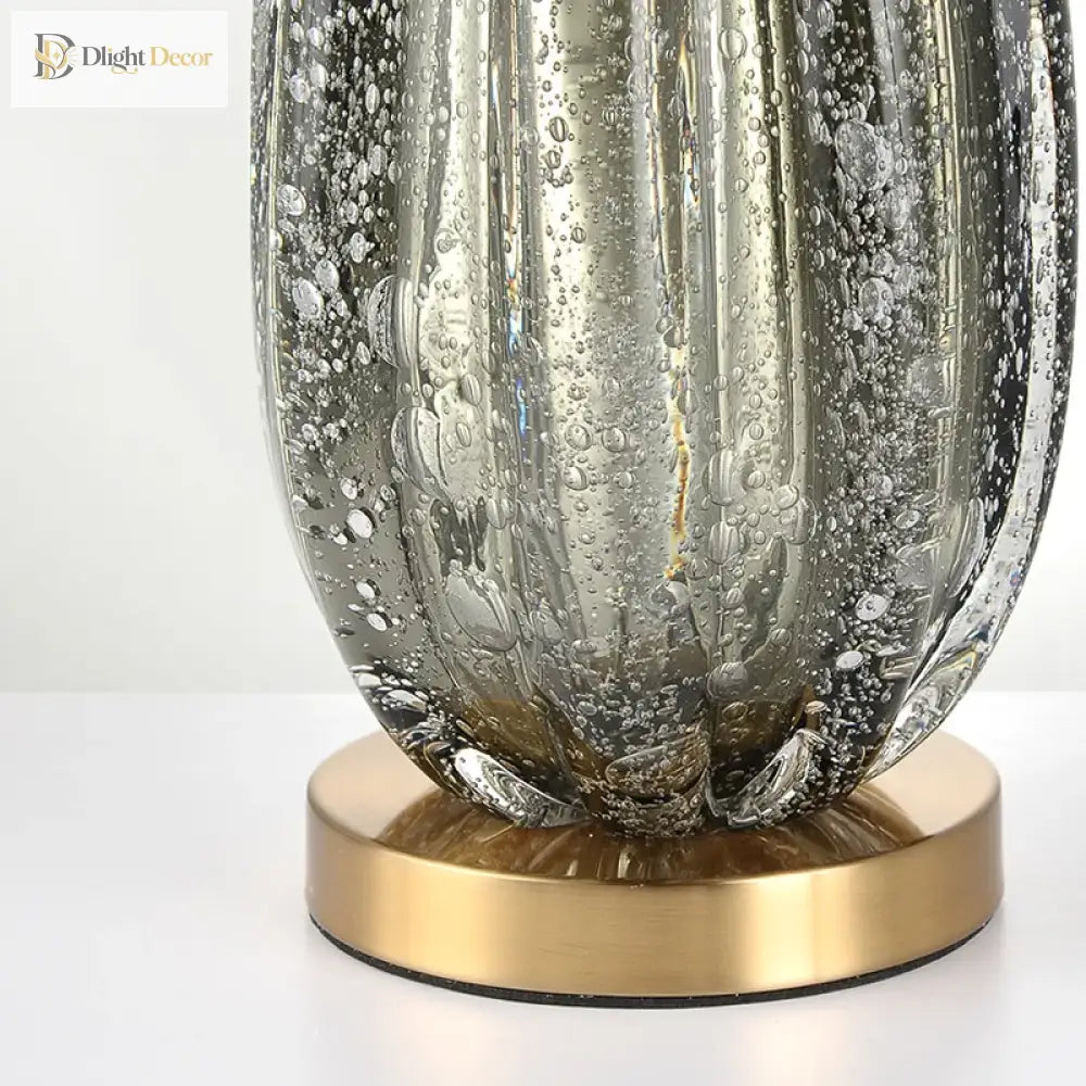 Green crystal glass lamp base with brass pedestal, detailed textured surface