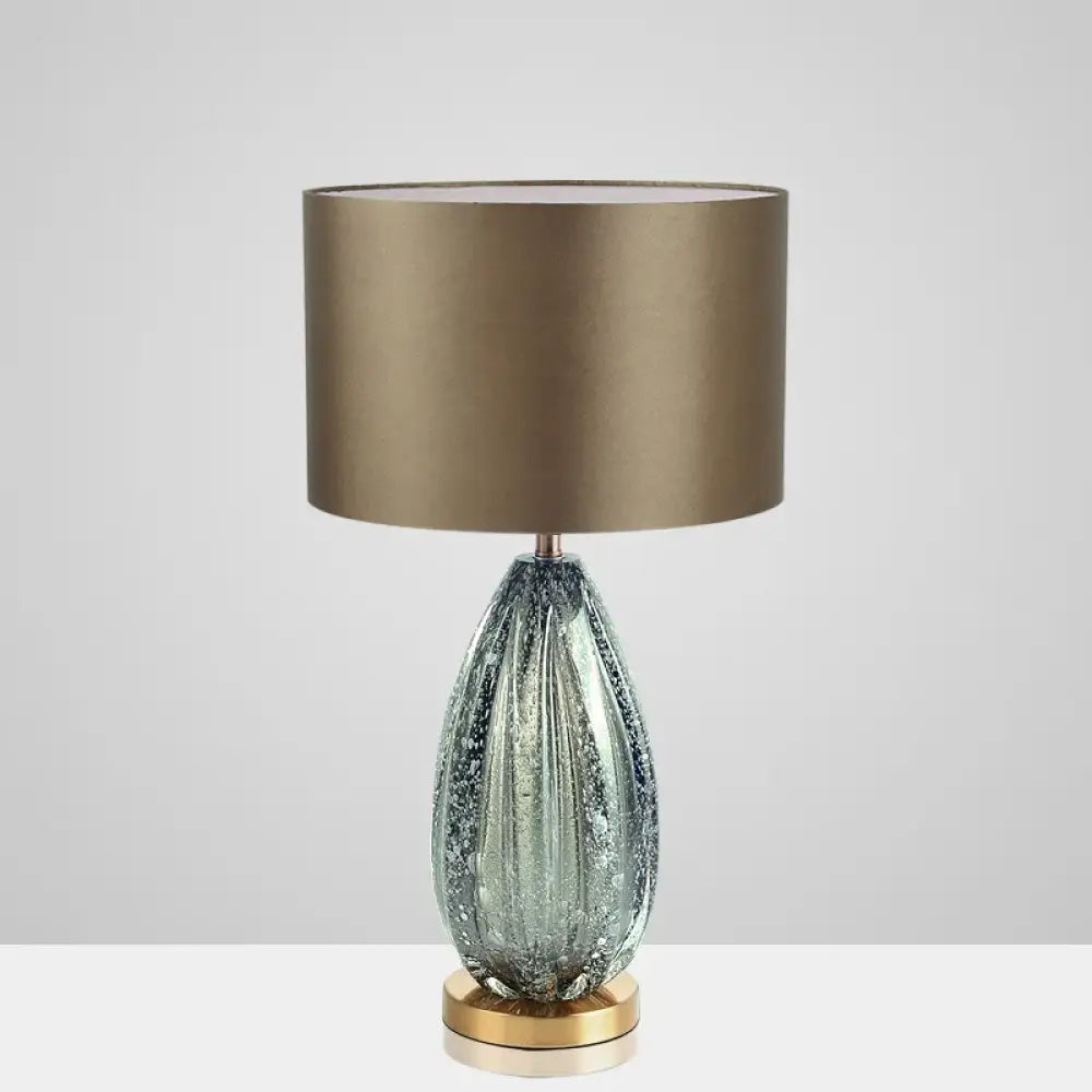 LED desk lamp with green ribbed crystal glass base and beige fabric shade