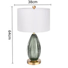 LED desk lamp with white drum shade and green crystal glass base, 64.5cm height