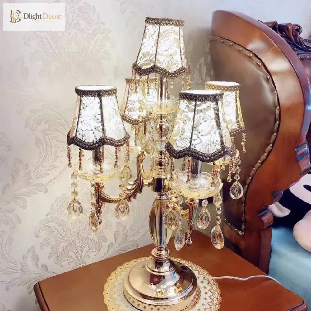 Gold crystal LED desk lamp with ornate pedestal base and hanging crystal drops from shades
