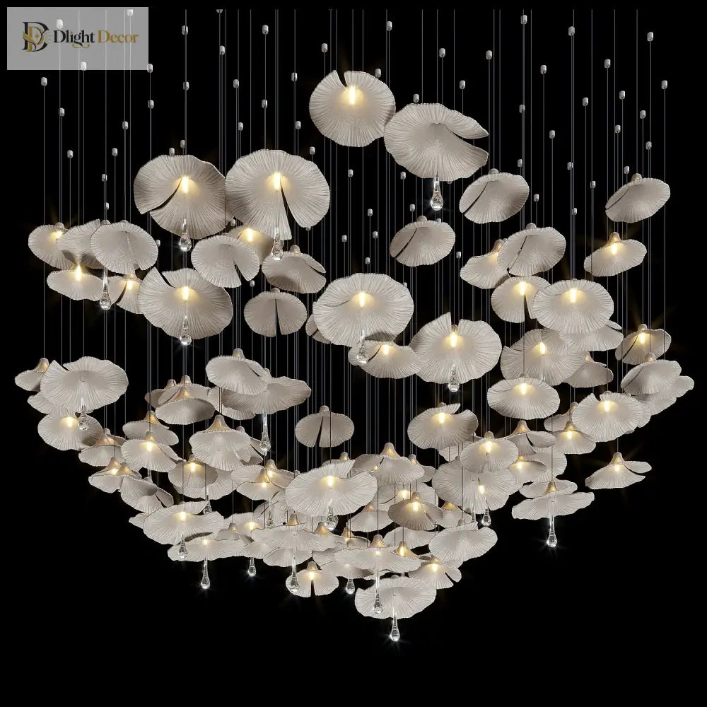 Mushroom-style ceramic chandelier with multiple glowing white shades on long metal cords