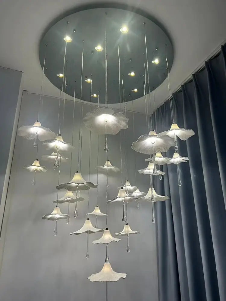 Mushroom-style ceramic chandelier with glowing white shades and hanging crystal drop accents