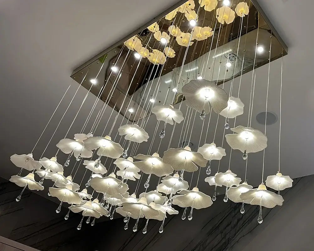 Mushroom ceramic chandelier overhead view with glowing white shades on hanging wires