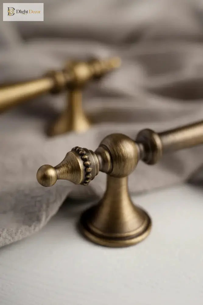 Antique brass cabinet handle with long stem and round pedestal base