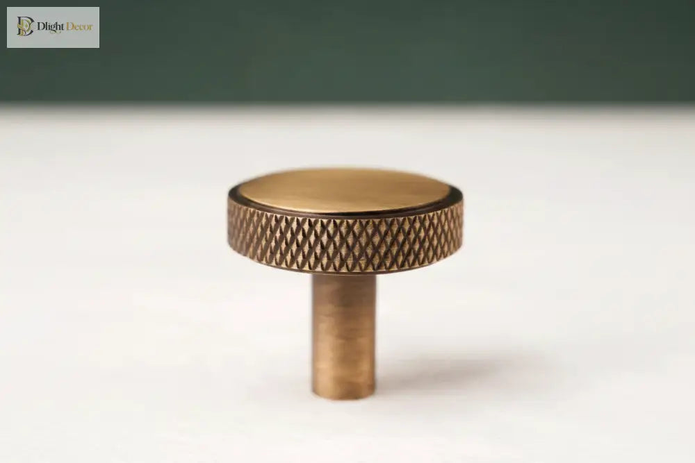 Antique brass round cabinet knob pull with cross-knurled textured rim