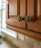Wooden cabinet with brass flower-shaped knobs and 'Santaya' branding.