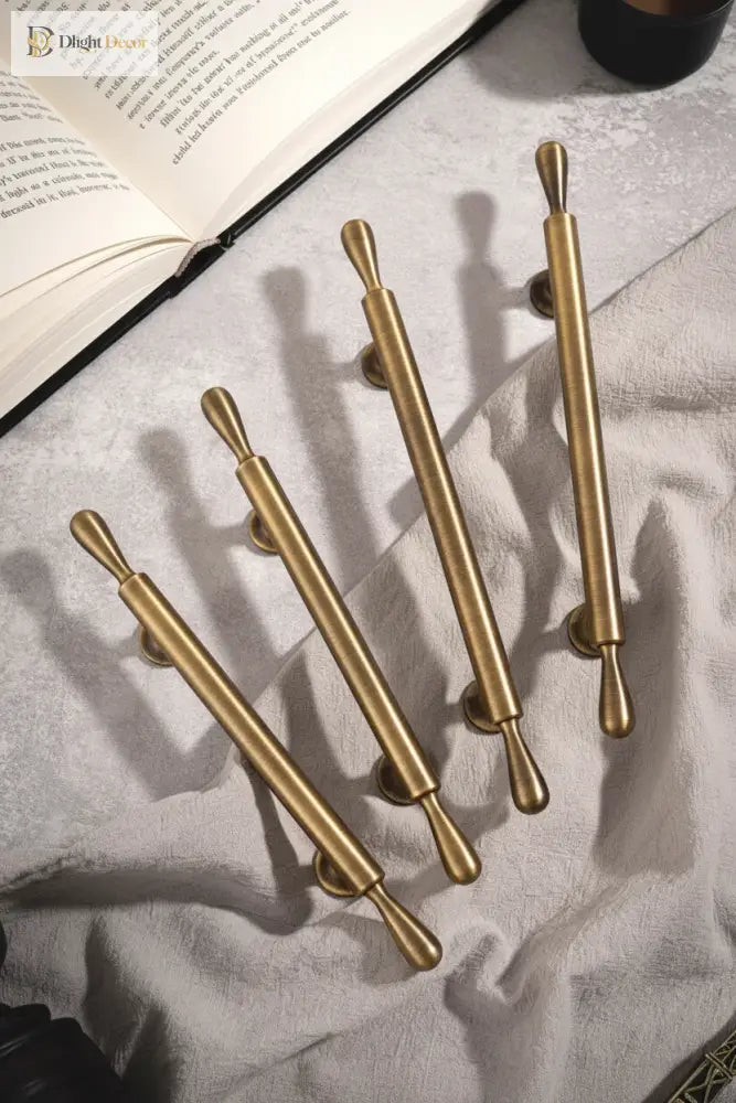 Antique brass bar cabinet handles with cylindrical posts and rounded grip ends
