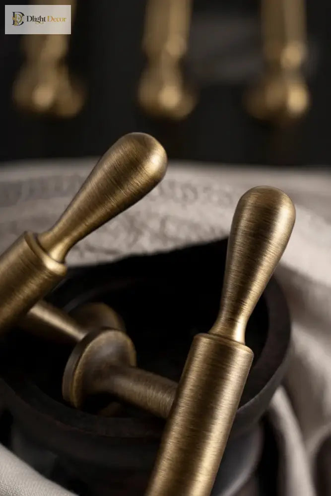 Bronze bar cabinet handles with curved finger grips and brushed metallic finish
